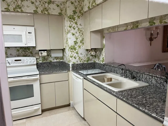 a kitchen with a stove sink and refrigerator