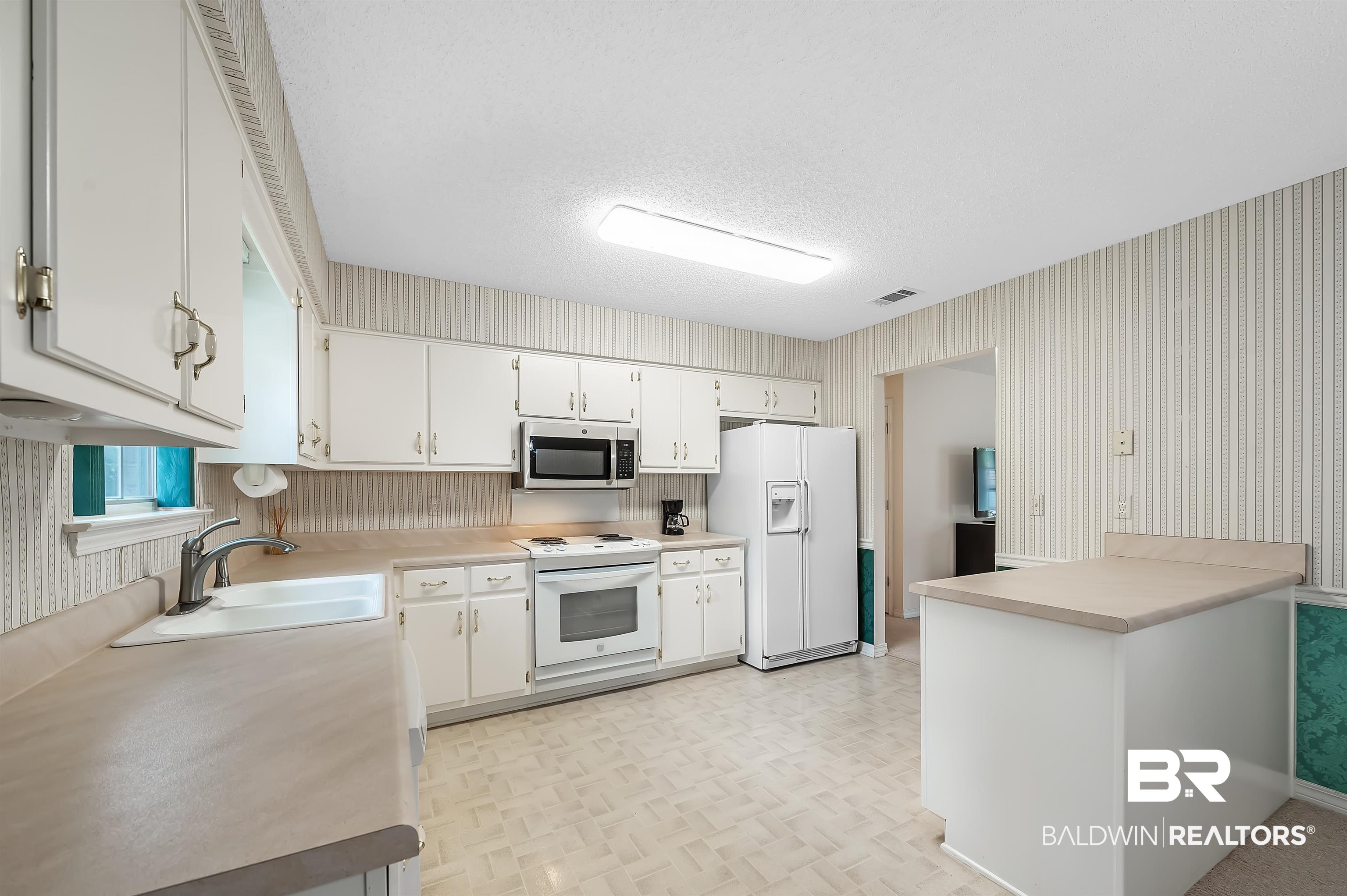1502 Mulberry Lane Foley, AL 36535 - Photo 12 of 45 Kitchen featuring white cabinetry, light parquet flooring, white appliances, and sink