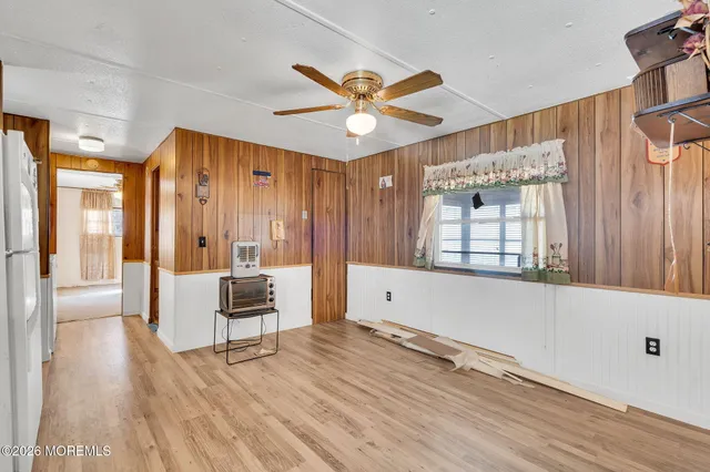 a living room with hardwood floor and a ceiling fan