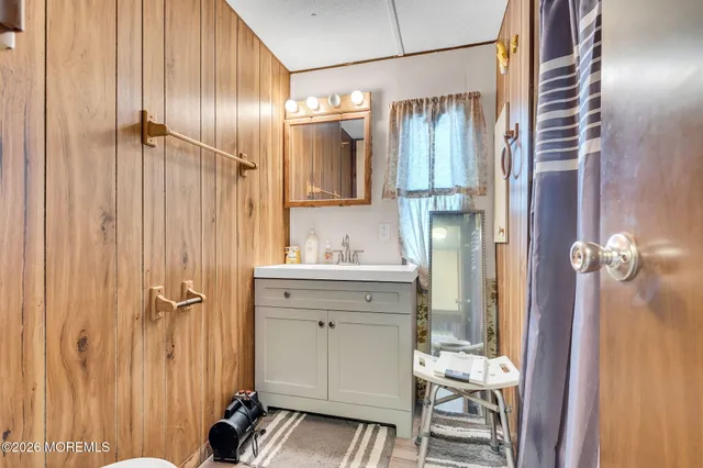 a bathroom with a sink a mirror and a shower