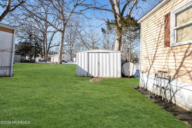 a view of a yard with large trees