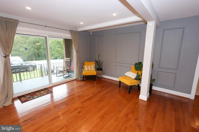 a living room with furniture window and a flat screen tv