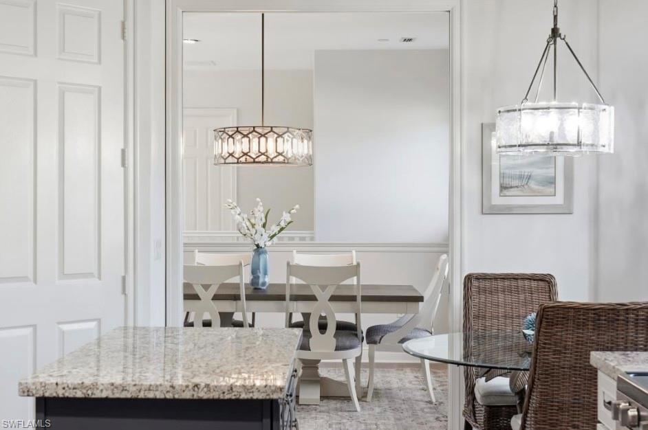 7842 Hawthorne Drive, Unit 1703 Naples, FL 34113 - Photo 15 of 31 a dining room with furniture and window