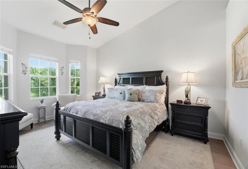 7842 Hawthorne Drive, Unit 1703 Naples, FL 34113 - Photo 20 of 31 a bed room with a bed and a chandelier