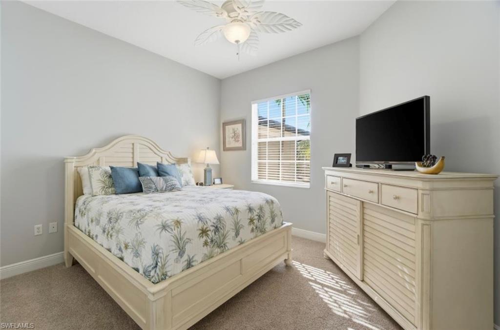 7842 Hawthorne Drive, Unit 1703 Naples, FL 34113 - Photo 23 of 31 a bedroom with a bed and a flat screen tv