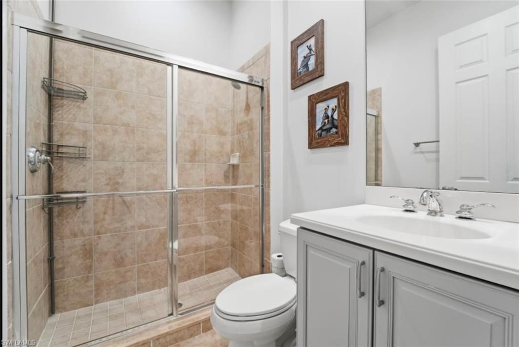 7842 Hawthorne Drive, Unit 1703 Naples, FL 34113 - Photo 27 of 31 a bathroom with a sink toilet and shower