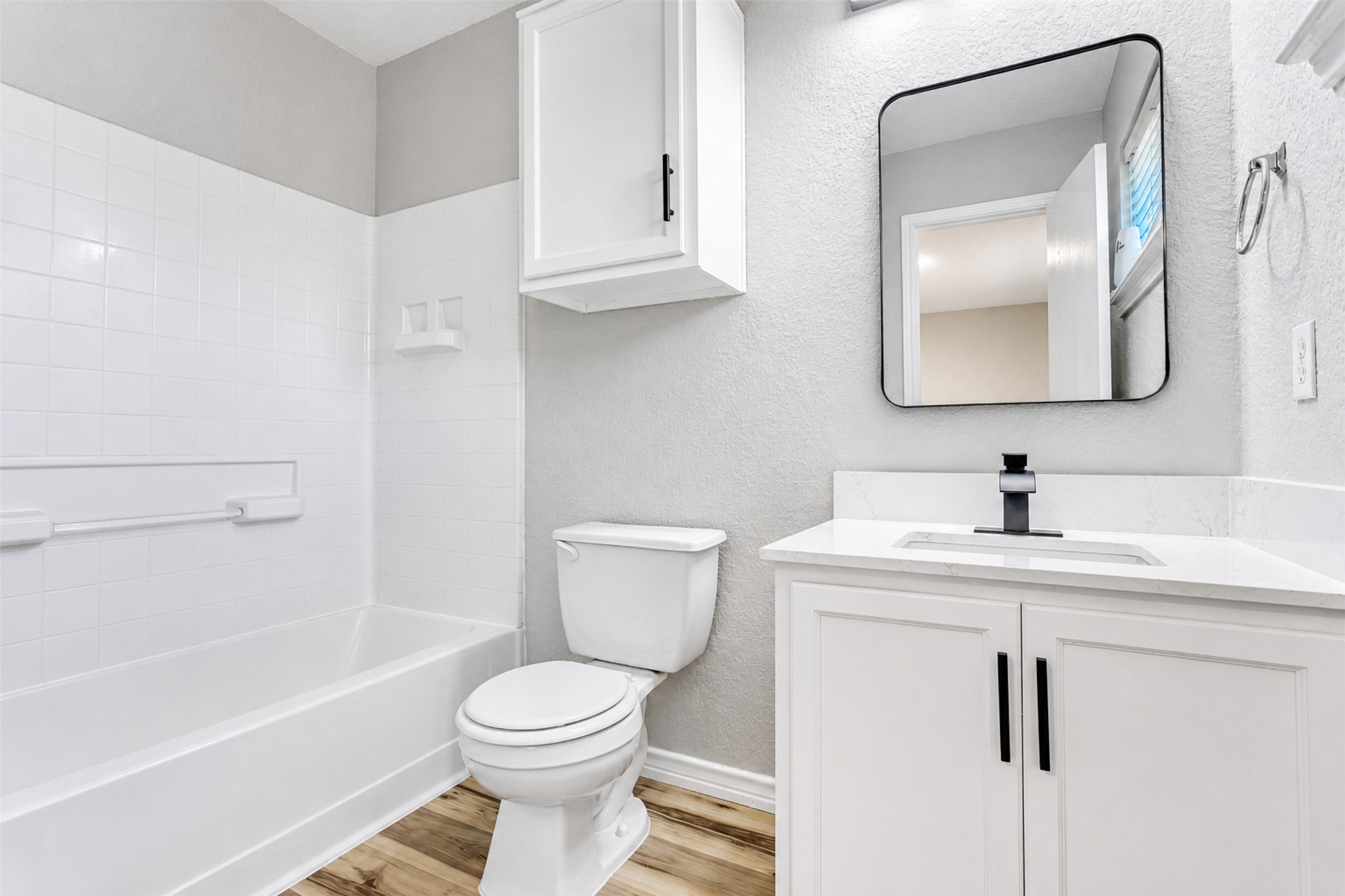 4523 Secure Lane Austin, TX 78725 - Photo 27 of 40 A pristine bathroom features white subway tile surrounding the tub, complemented by sleek vanity and modern fixtures.