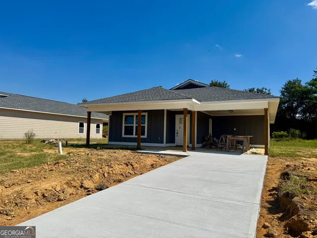 a front view of house with outdoor seating