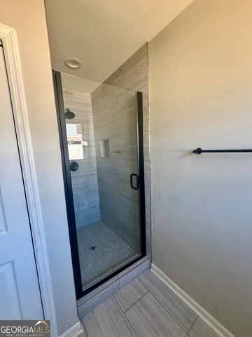a bathroom with a glass door shower