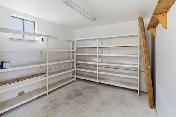 a view of room with wooden floor and a rug