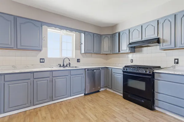 a kitchen with stainless steel appliances granite countertop a stove and a sink