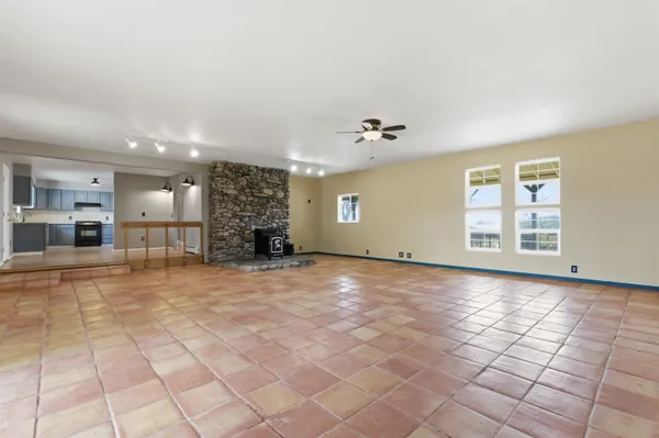 a view of a livingroom with furniture and a window