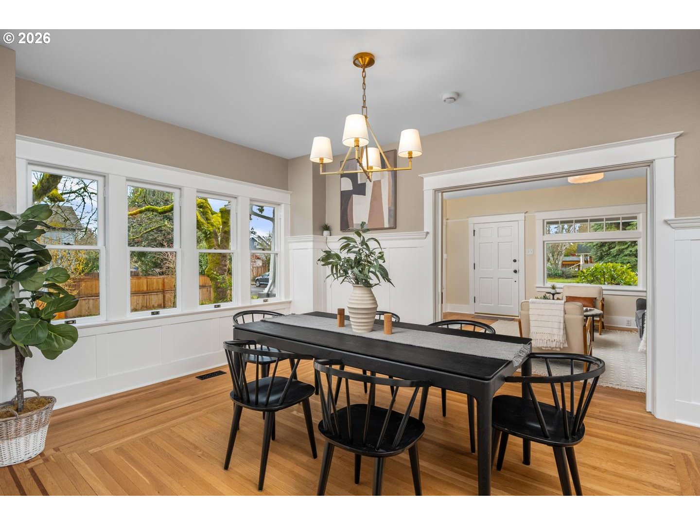 1239 Northeast Sumner Street Portland, OR 97211 - Photo 11 of 48 a dining room with wooden floor a chandelier a wooden table and chairs