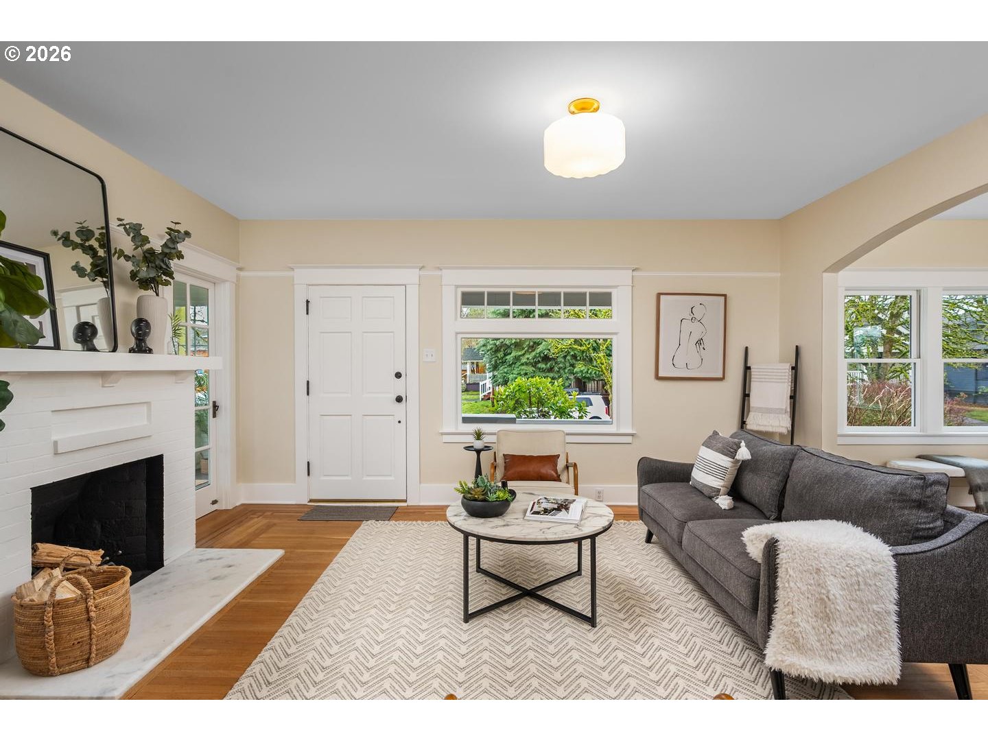1239 Northeast Sumner Street Portland, OR 97211 - Photo 6 of 48 a living room with furniture a fireplace and potted plants