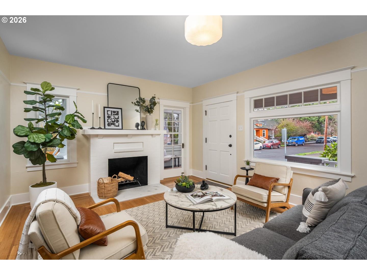 1239 Northeast Sumner Street Portland, OR 97211 - Photo 7 of 48 a living room with furniture a fireplace and a potted plant