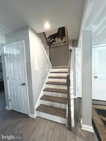 a view of a hallway with entryway wooden floor and front door