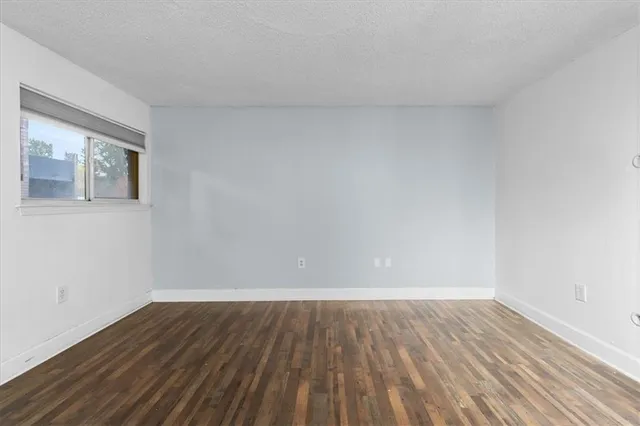 a view of an empty room and wooden floor