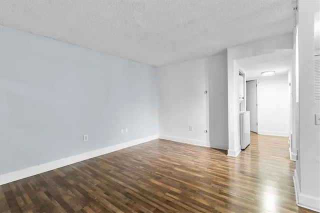 a view of an empty room and wooden floor