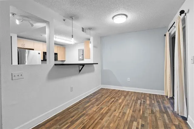 a view of a kitchen with wooden floor and a sink