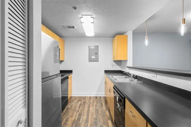 a kitchen with a refrigerator and a sink