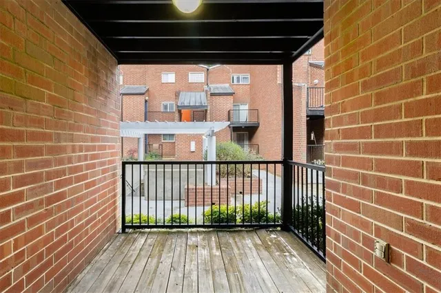 a view of a balcony with wooden floor and iron walls