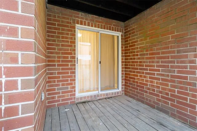 a view of a door with wooden floor and a window