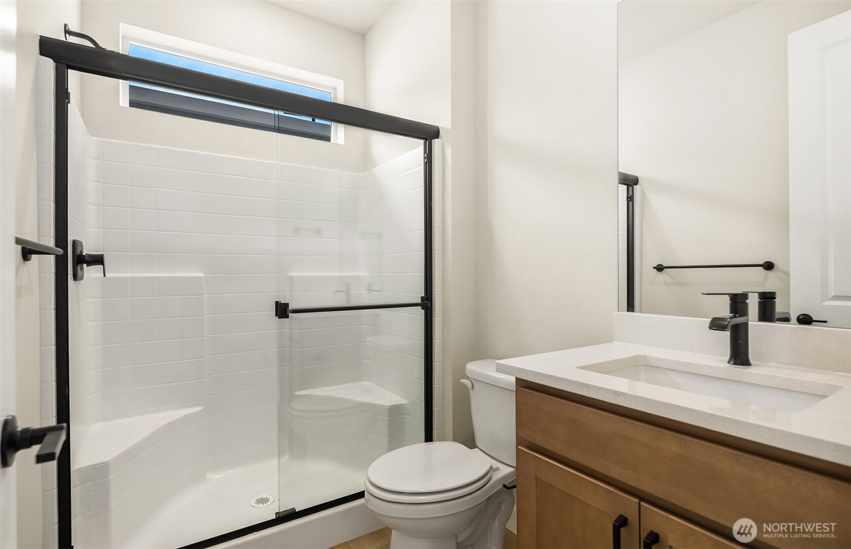 23361 Arbors Terrace Road Northeast, Unit 21 Kingston, WA 98346 - Photo 17 of 19 a bathroom with a granite countertop sink toilet and shower