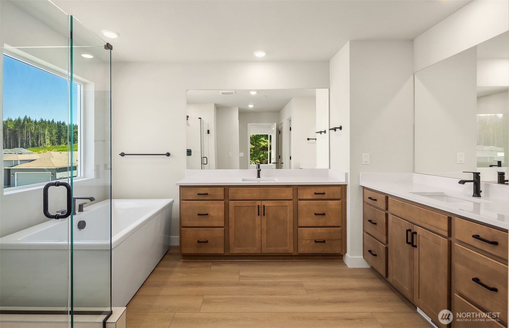 23361 Arbors Terrace Road Northeast, Unit 21 Kingston, WA 98346 - Photo 18 of 19 a spacious bathroom with a double vanity sink a mirror a bathtub and shower