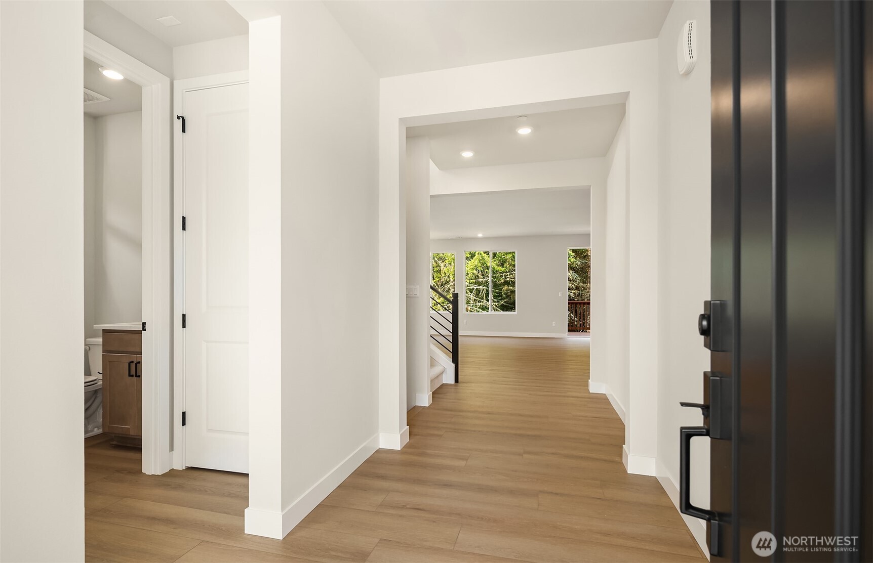 23361 Arbors Terrace Road Northeast, Unit 21 Kingston, WA 98346 - Photo 2 of 19 a view of a hallway with wooden floor