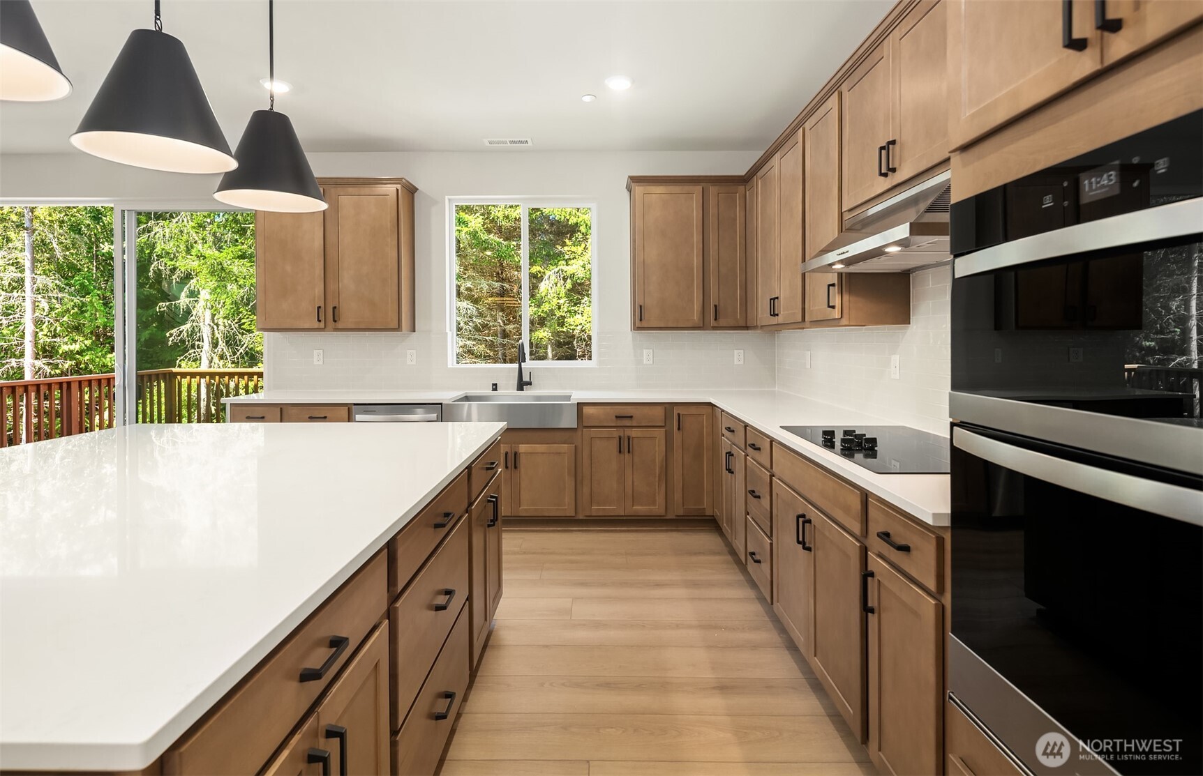23361 Arbors Terrace Road Northeast, Unit 21 Kingston, WA 98346 - Photo 6 of 19 a kitchen with stainless steel appliances a sink dishwasher a stove a microwave oven and a refrigerator with wooden floor