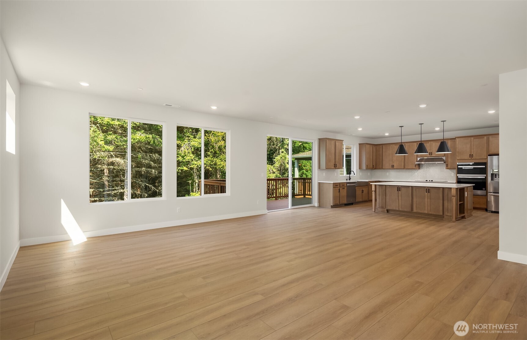 23361 Arbors Terrace Road Northeast, Unit 21 Kingston, WA 98346 - Photo 9 of 19 a view of an empty room with wooden floor and a window