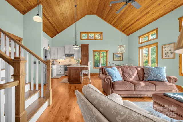 a living room with furniture fireplace and a large window
