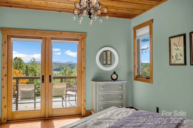 a bathroom with a granite countertop bathtub a sink and a large mirror