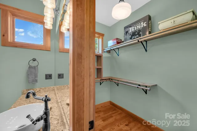 a view of a kitchen with furniture and wooden floor