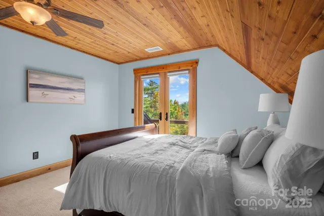 a bed room with a bed and a chandelier