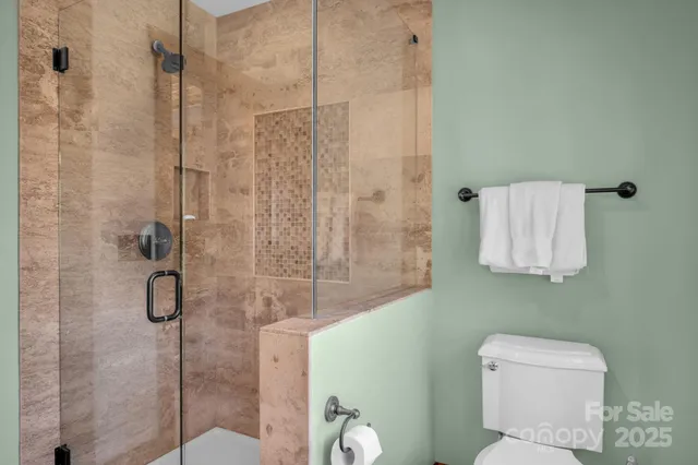 a bathroom that has a toilet shower and a sink