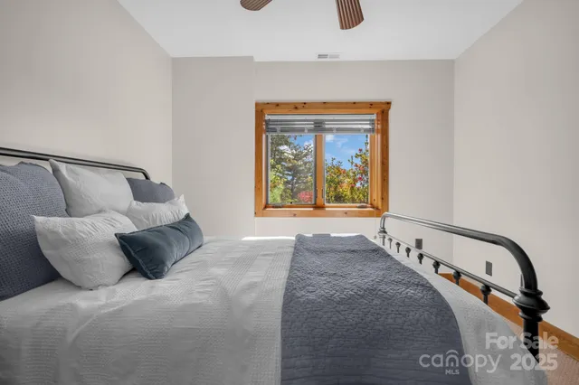 a bedroom with a bed and a chandelier