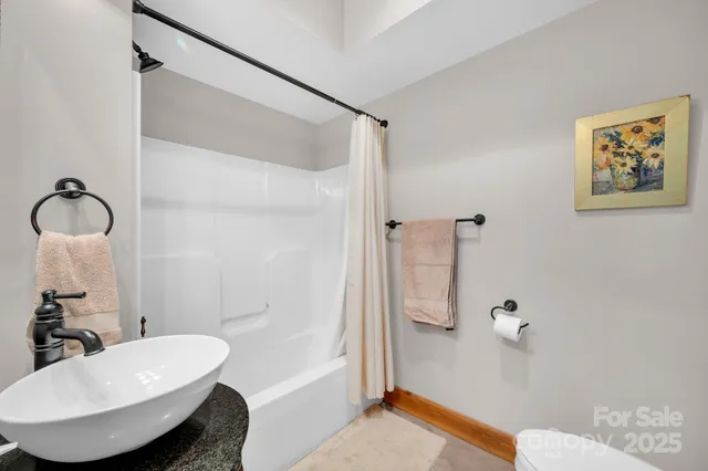 a bathroom with a toilet a sink and a mirror