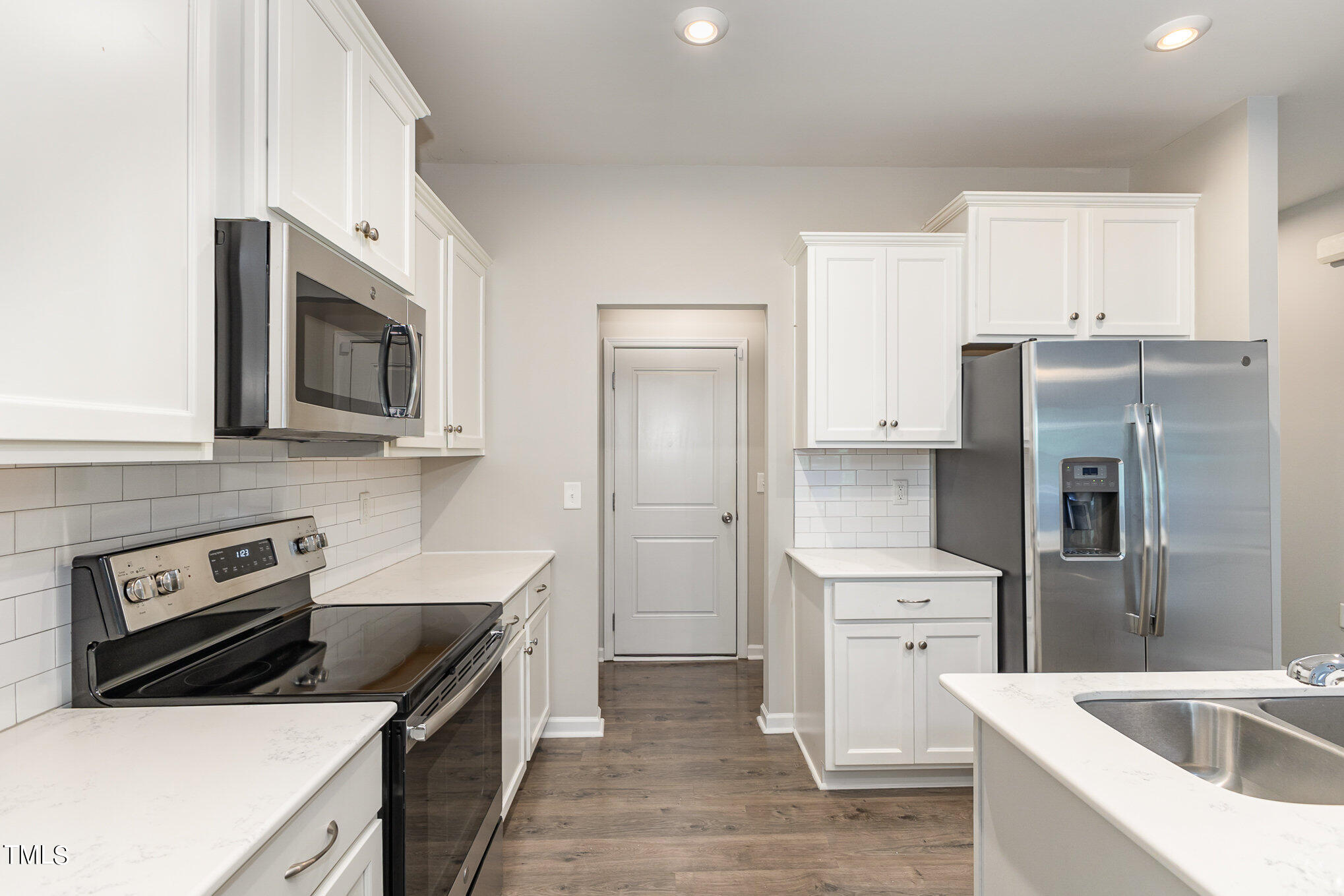 3607 Water Mist Lane Raleigh, NC 27604 - Photo 14 of 30 a kitchen with stainless steel appliances a stove microwave and refrigerator