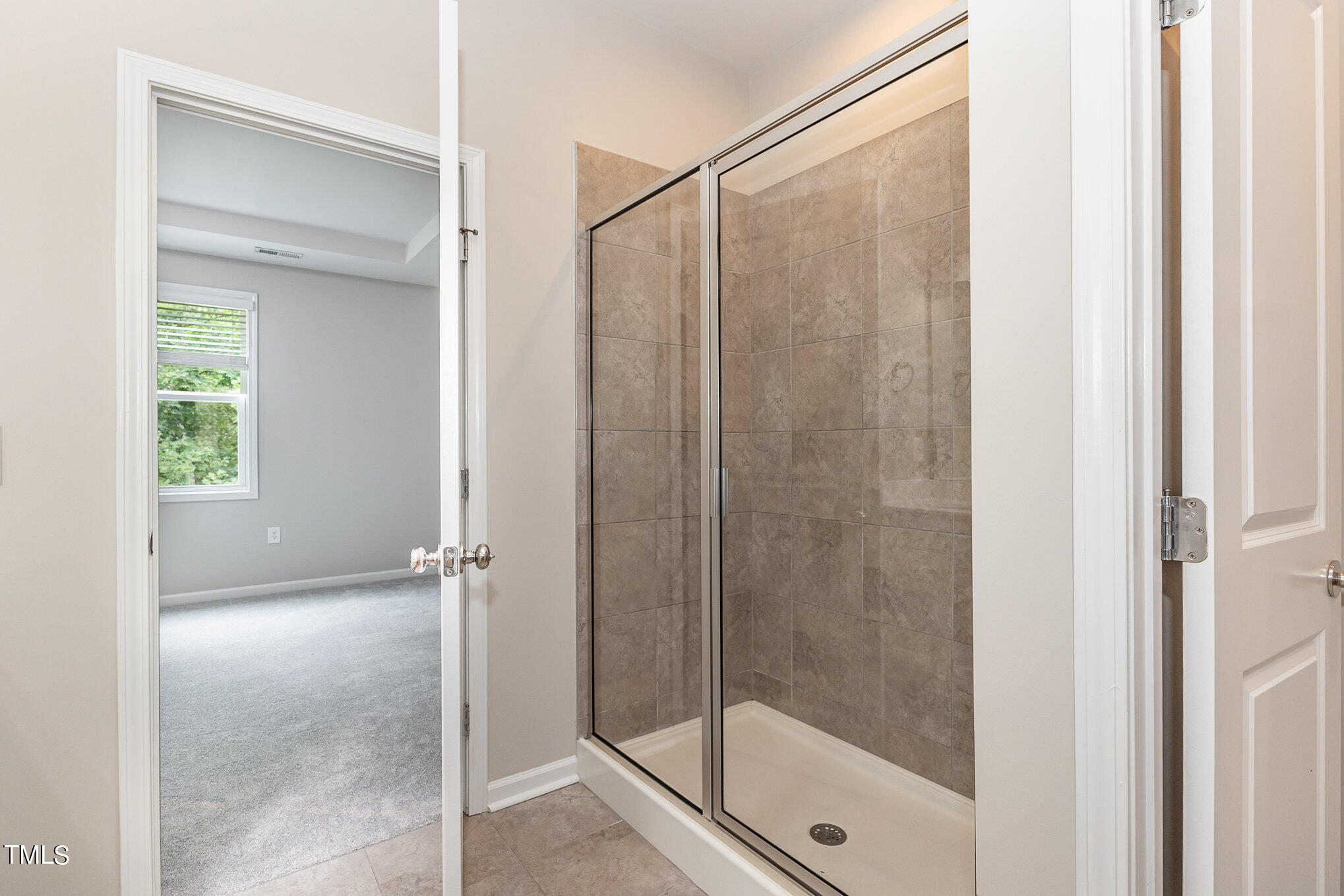 3607 Water Mist Lane Raleigh, NC 27604 - Photo 22 of 30 a bathroom with a glass shower door