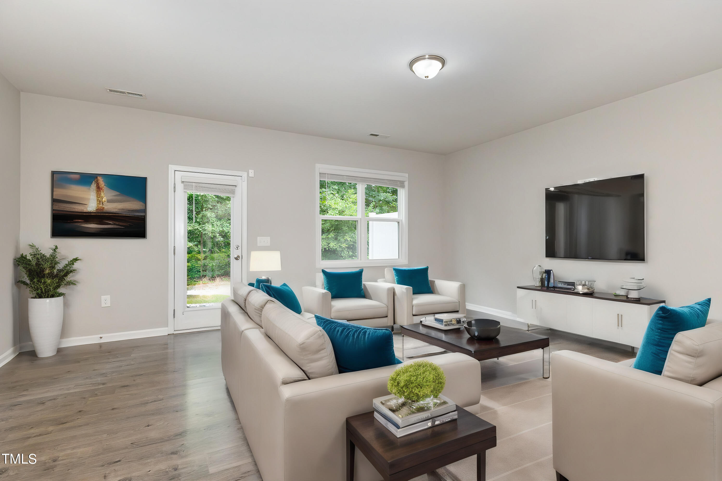 3607 Water Mist Lane Raleigh, NC 27604 - Photo 7 of 30 a living room with furniture a flat screen tv and a large window
