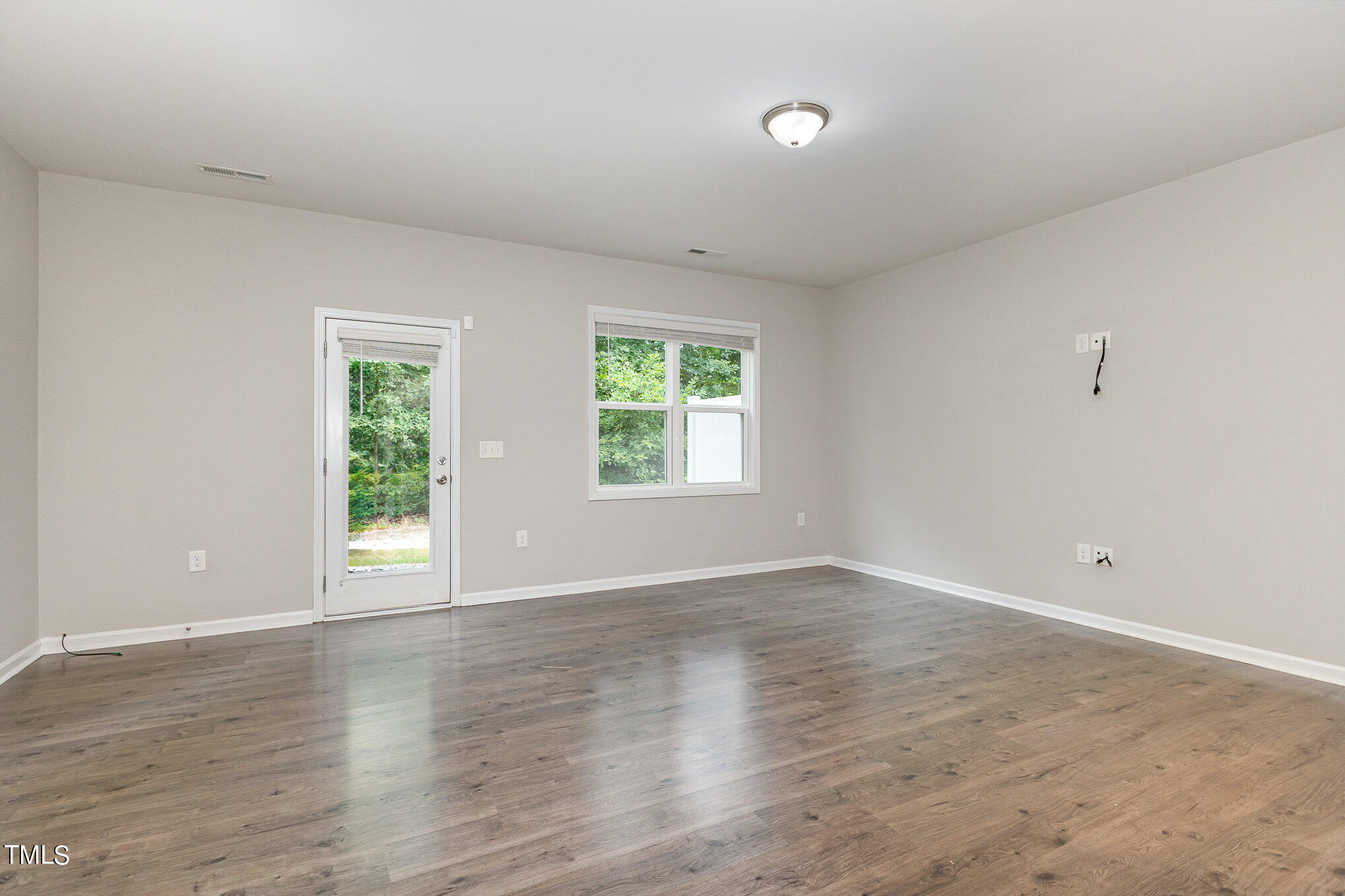 3607 Water Mist Lane Raleigh, NC 27604 - Photo 8 of 30 an empty room with wooden floor and windows