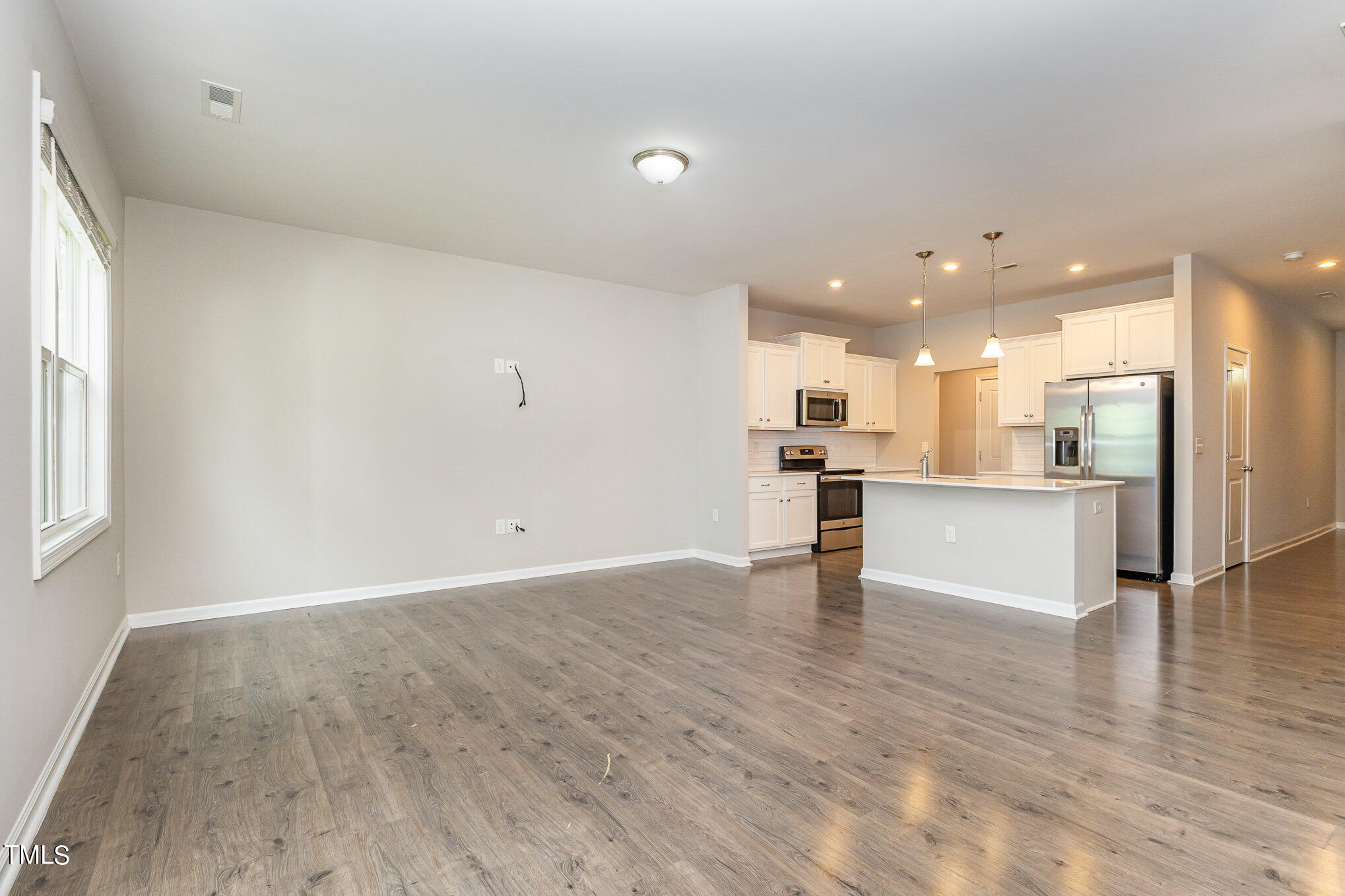 3607 Water Mist Lane Raleigh, NC 27604 - Photo 10 of 30 a view of a kitchen with a kitchen island wooden floor and a window