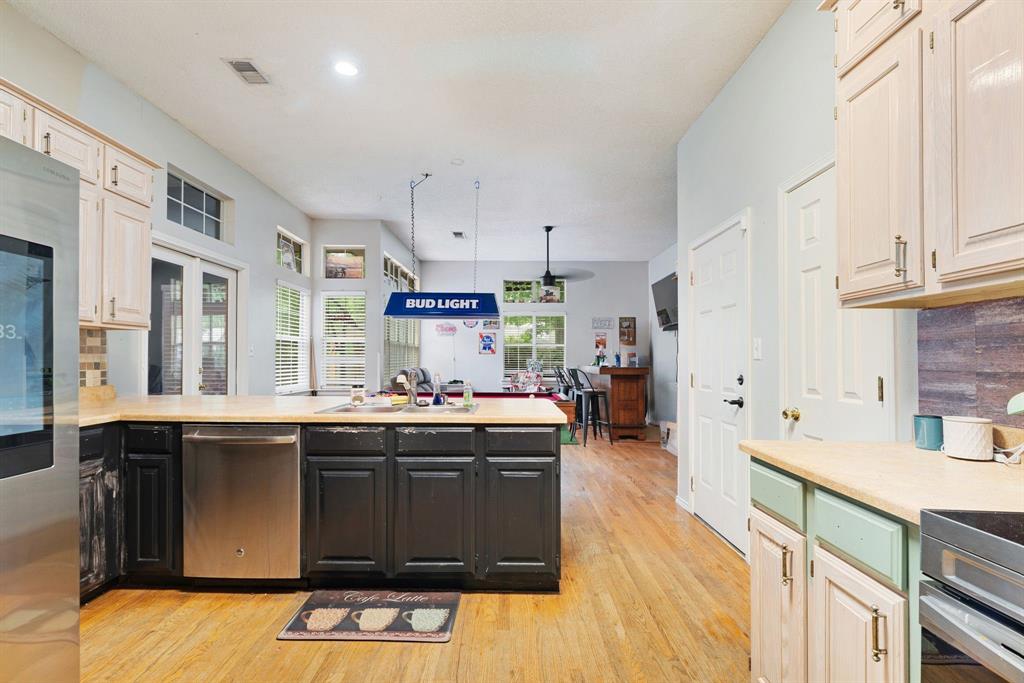455 Timber Lakes Drive Powderly, TX 75473 - Photo 4 of 18 a kitchen with kitchen island granite countertop a sink stove and cabinets