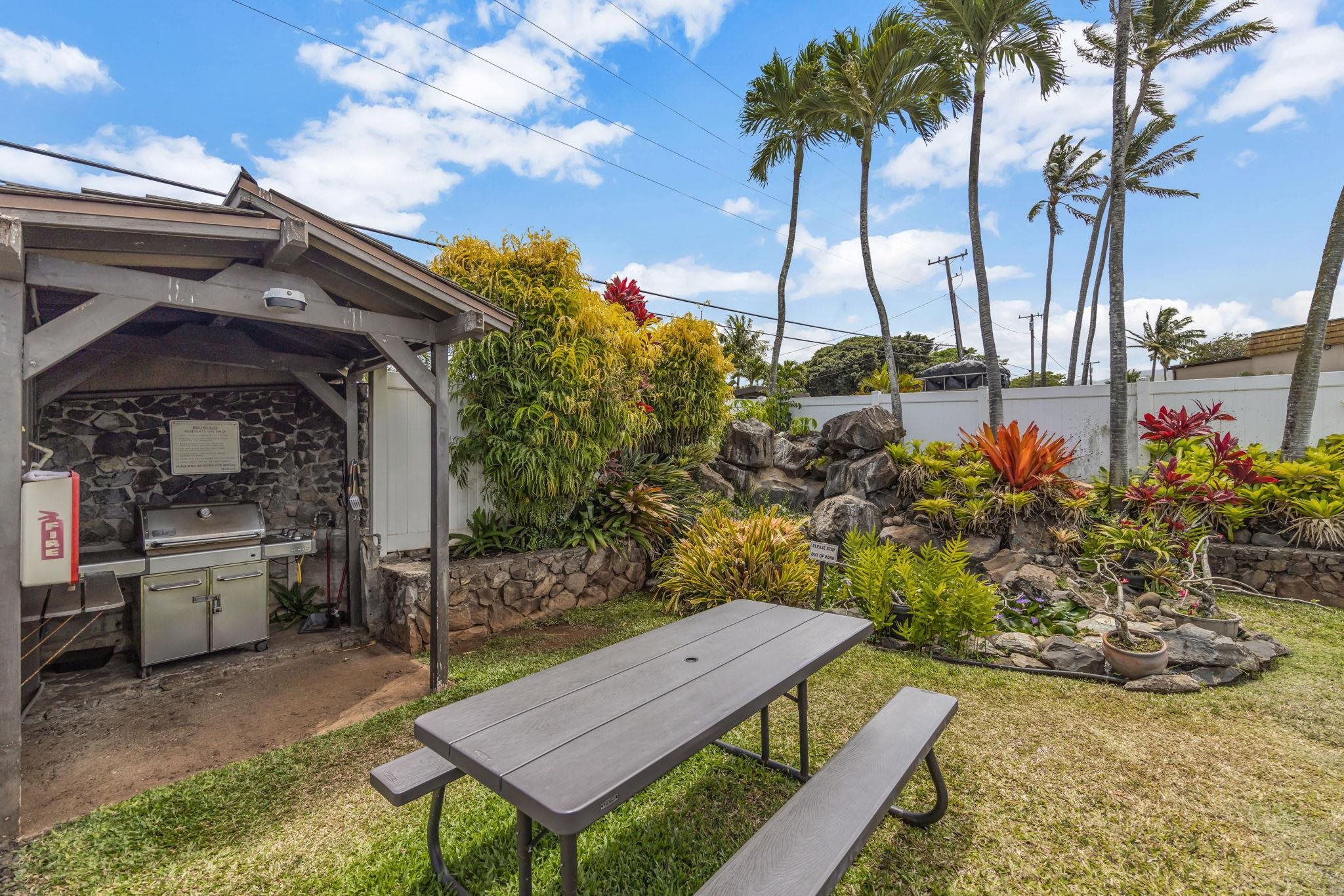 120 Hui Rd F, Unit E16 Lahaina, HI 96761 - Photo 19 of 24 a view of a backyard with plants and a patio