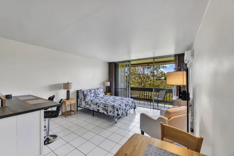 a bedroom with furniture and large window