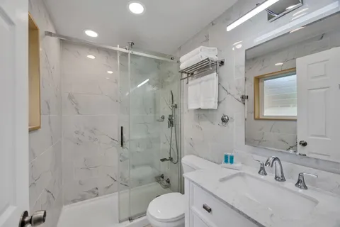a bathroom with a sink toilet tub and shower