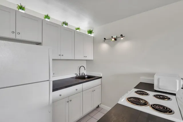 a kitchen with cabinets and appliances