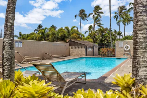 a view of swimming pool with a lounge chairs
