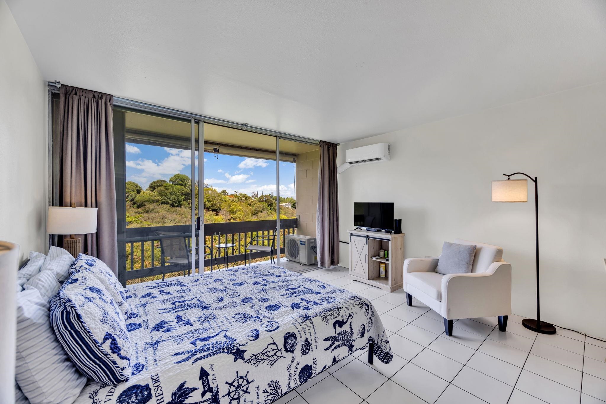 120 Hui Rd F, Unit E16 Lahaina, HI 96761 - Photo 9 of 24 a bedroom with a bed and large windows